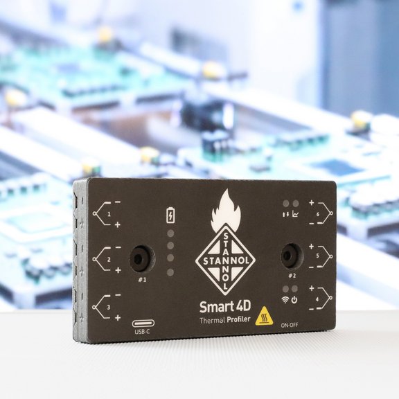 The picture shows Stannol's Thermal Profiler, a rectangular black box with various inputs and outputs. The Stannol logo can be seen in the centre. 